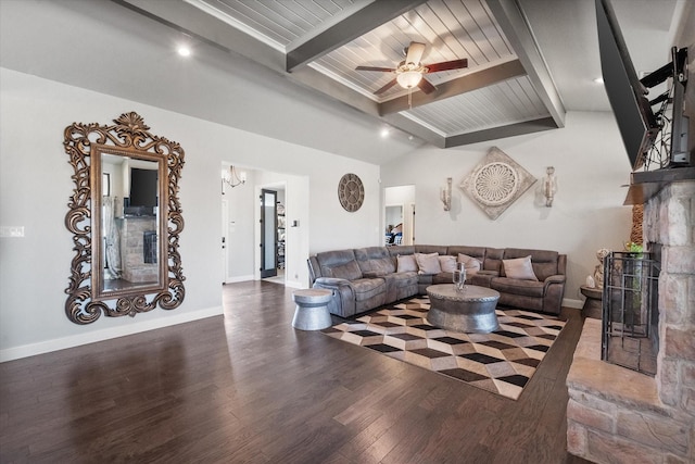 living area with a fireplace with raised hearth, lofted ceiling with beams, ceiling fan with notable chandelier, baseboards, and dark wood finished floors