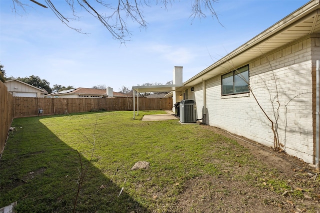 view of yard featuring central air condition unit and a patio area