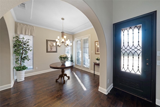 entryway with a chandelier, french doors, crown molding, and dark hardwood / wood-style flooring