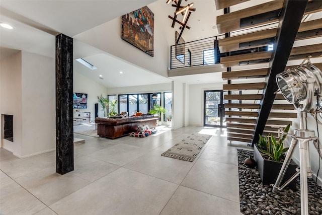 foyer entrance with high vaulted ceiling and a wealth of natural light