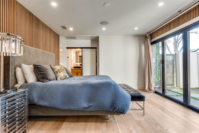 bedroom featuring light wood-type flooring and access to exterior