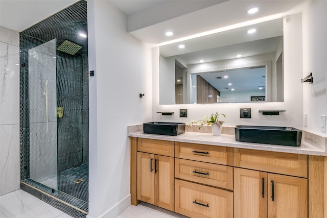 bathroom featuring a tile shower and vanity