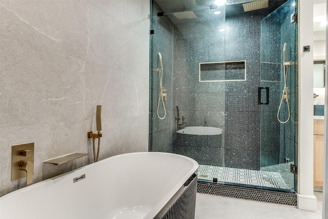 bathroom featuring tile walls, separate shower and tub, and tile patterned floors