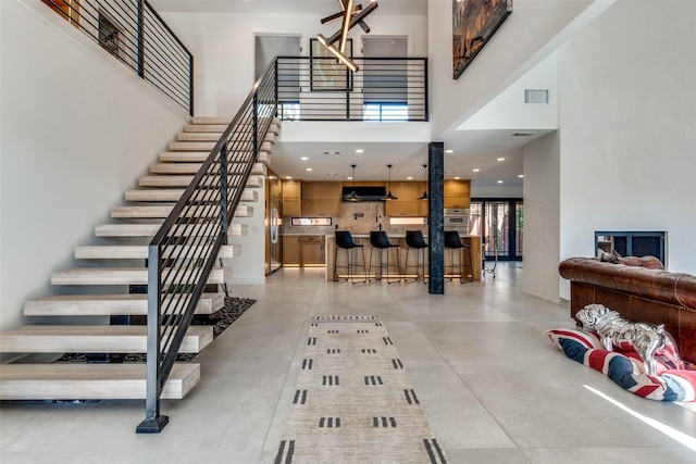 staircase with a towering ceiling