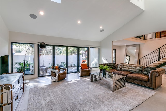 living room with high vaulted ceiling, french doors, and a wealth of natural light