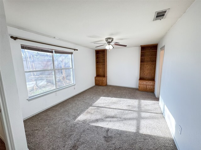 unfurnished bedroom featuring ceiling fan and carpet floors