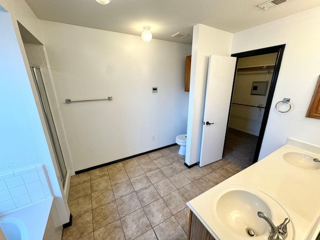 full bathroom featuring toilet, plus walk in shower, tile patterned floors, and vanity