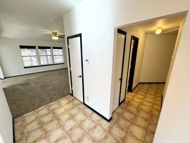 hall with light colored carpet