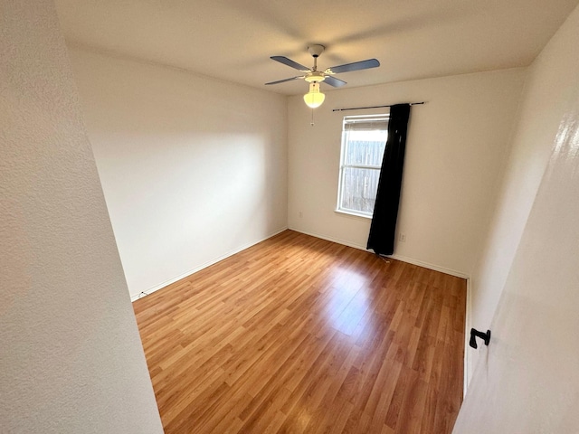 unfurnished room featuring ceiling fan and hardwood / wood-style floors