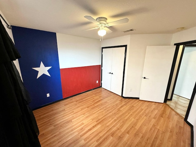 unfurnished bedroom featuring ceiling fan and light wood-type flooring