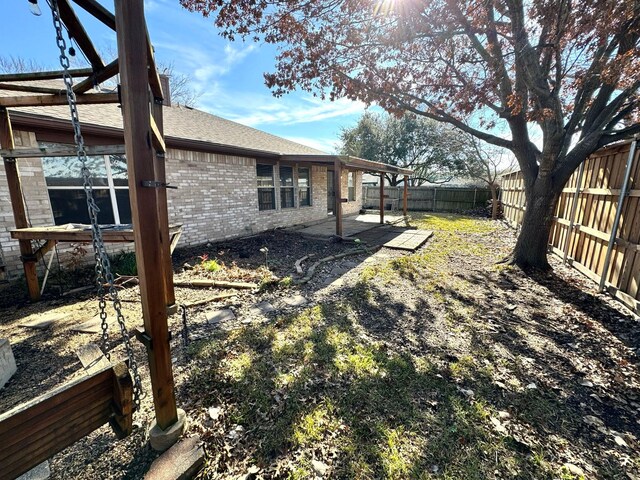 back of house with a patio area and a yard