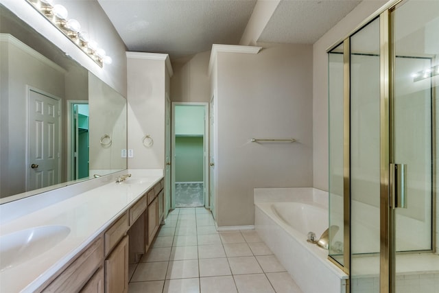 bathroom with tile patterned flooring, vanity, independent shower and bath, and a textured ceiling