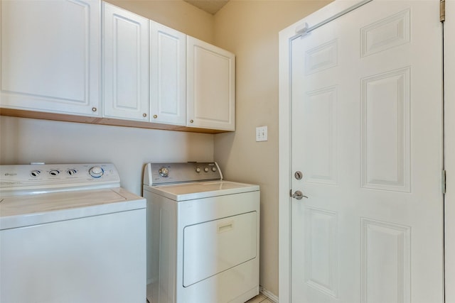 laundry room featuring cabinets and washer and dryer