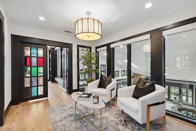 sitting room featuring french doors and light hardwood / wood-style floors