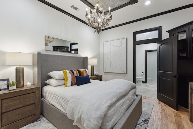 bedroom featuring a notable chandelier, light hardwood / wood-style flooring, and crown molding