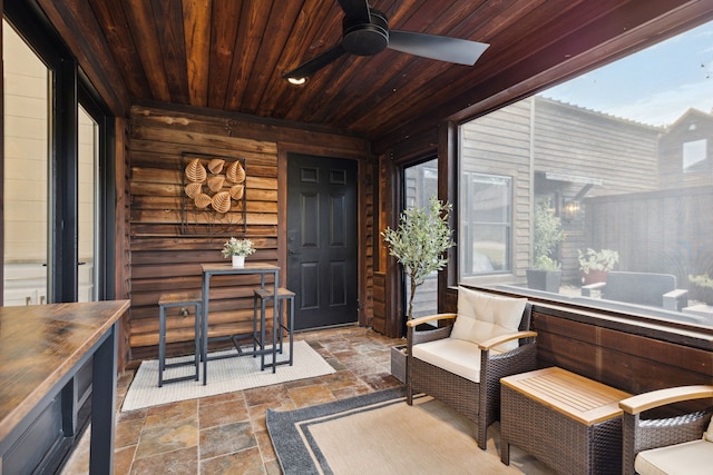 sunroom featuring ceiling fan and wooden ceiling