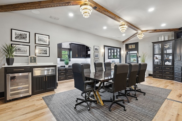 office featuring beverage cooler, light hardwood / wood-style floors, and lofted ceiling with beams