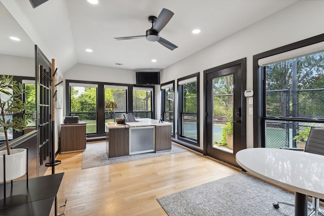 interior space featuring ceiling fan, light wood-type flooring, vaulted ceiling, and plenty of natural light