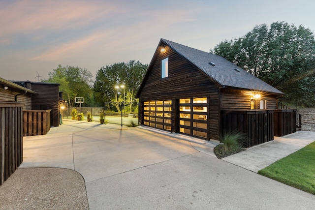 view of garage at dusk