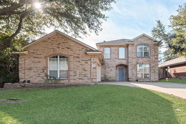 view of front facade with a front lawn and a garage