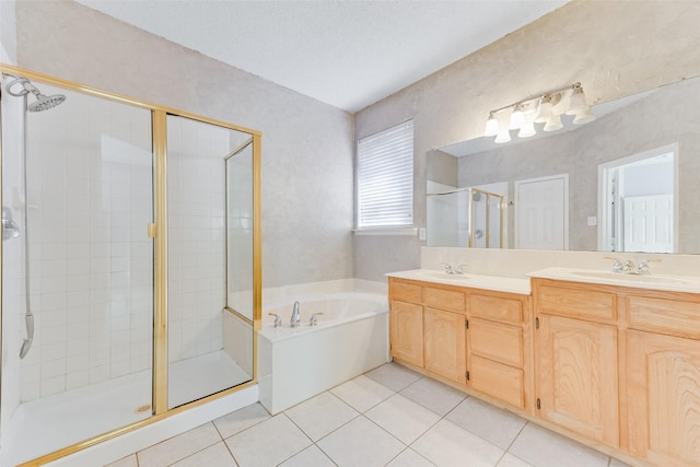 bathroom featuring vanity, plus walk in shower, tile patterned flooring, and a textured ceiling