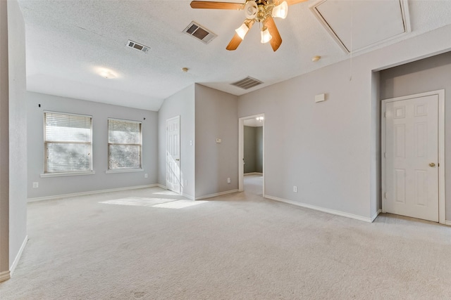 carpeted spare room with ceiling fan and a textured ceiling