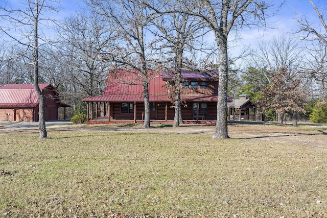 exterior space with covered porch and a front lawn