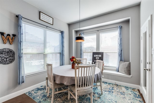 dining room with a healthy amount of sunlight and hardwood / wood-style flooring