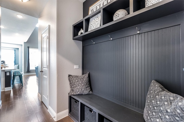 mudroom with lofted ceiling and dark wood-type flooring