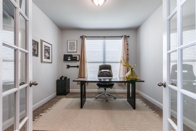 carpeted home office with french doors