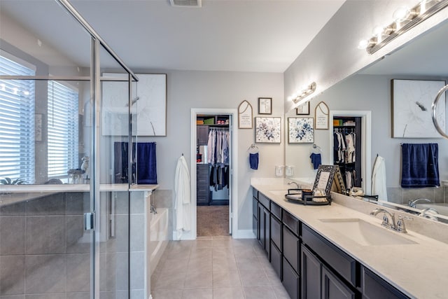 bathroom featuring independent shower and bath, vanity, and tile patterned floors