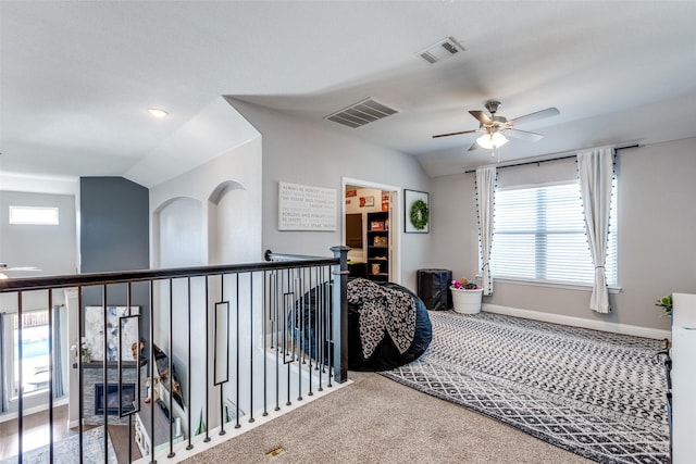 bedroom with carpet floors, ceiling fan, and vaulted ceiling