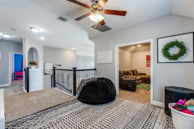 recreation room with vaulted ceiling, ceiling fan, and carpet