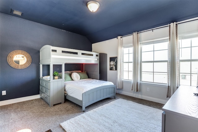 carpeted bedroom with vaulted ceiling