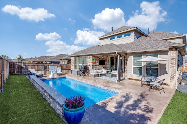 view of swimming pool with a lawn, a grill, a patio, and an outdoor living space