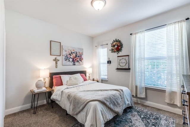 bedroom with multiple windows and carpet flooring