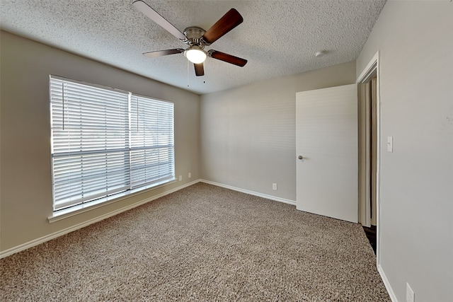 unfurnished room featuring a textured ceiling, ceiling fan, and carpet