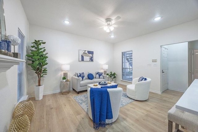 living room featuring light hardwood / wood-style floors and ceiling fan