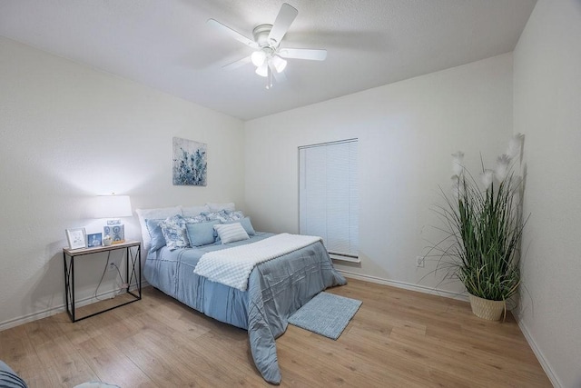 bedroom featuring ceiling fan and light hardwood / wood-style flooring