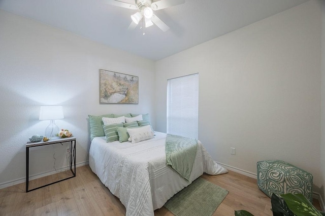 bedroom with light hardwood / wood-style floors and ceiling fan