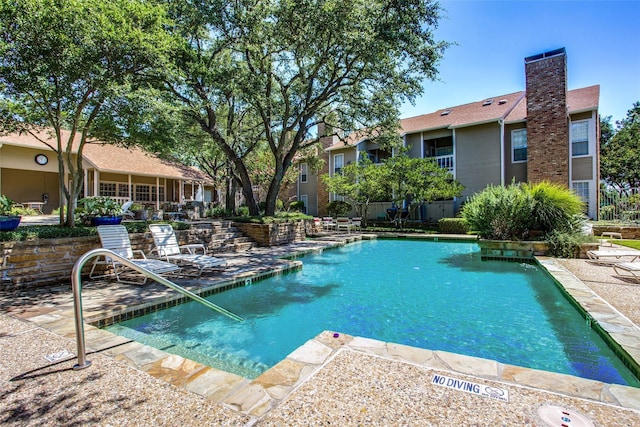 view of swimming pool featuring a patio area