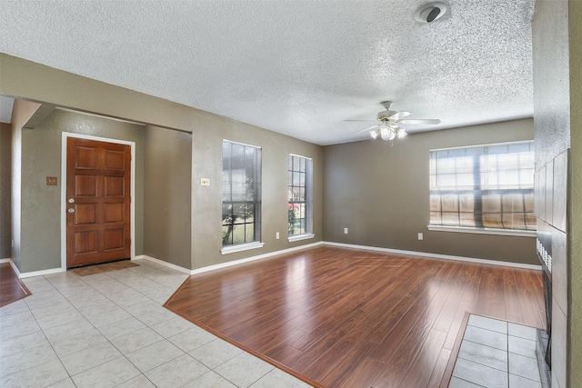 entryway featuring a textured ceiling, ceiling fan, and light hardwood / wood-style floors