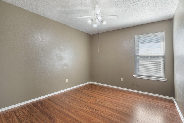 unfurnished room with ceiling fan, a textured ceiling, and hardwood / wood-style floors