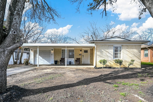 single story home featuring covered porch and a garage