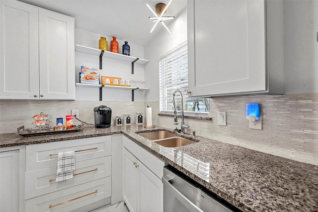 kitchen featuring white cabinets, decorative backsplash, and sink