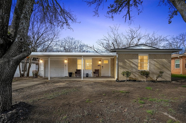 single story home featuring a garage and a carport