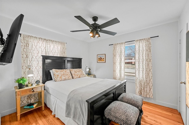 bedroom with ceiling fan and hardwood / wood-style floors