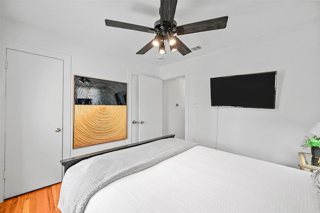 bedroom with ceiling fan and hardwood / wood-style floors