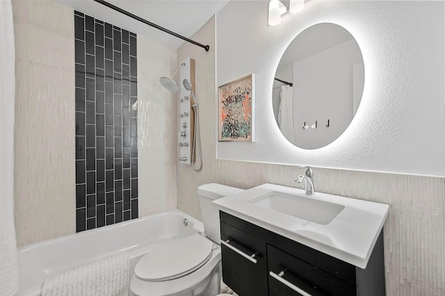 full bathroom with vanity, tiled shower / bath combo, and toilet