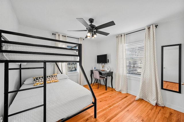 bedroom with ceiling fan and hardwood / wood-style flooring